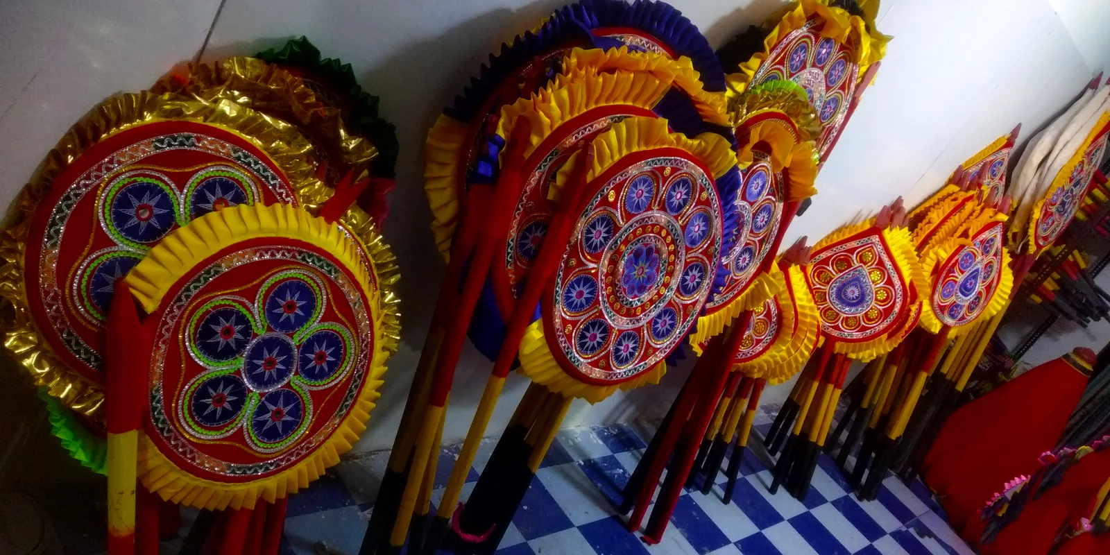 Red, yellow and purple appliqué objects arranged in a Pipili display.